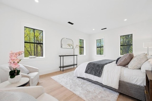 bedroom featuring baseboards, recessed lighting, light wood-style flooring, and visible vents