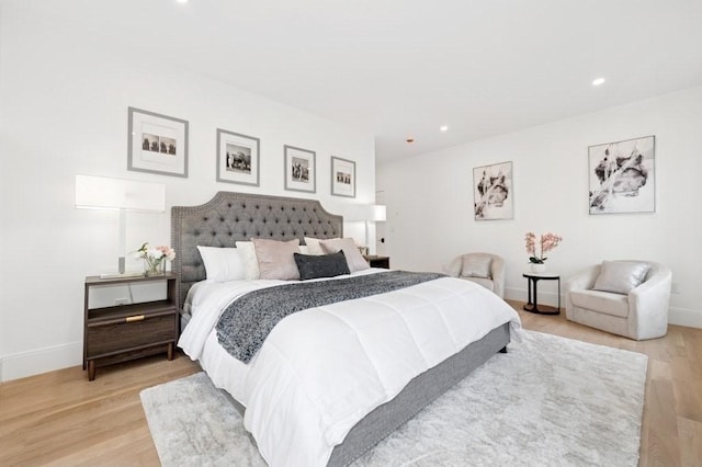 bedroom with recessed lighting, baseboards, and light wood-type flooring