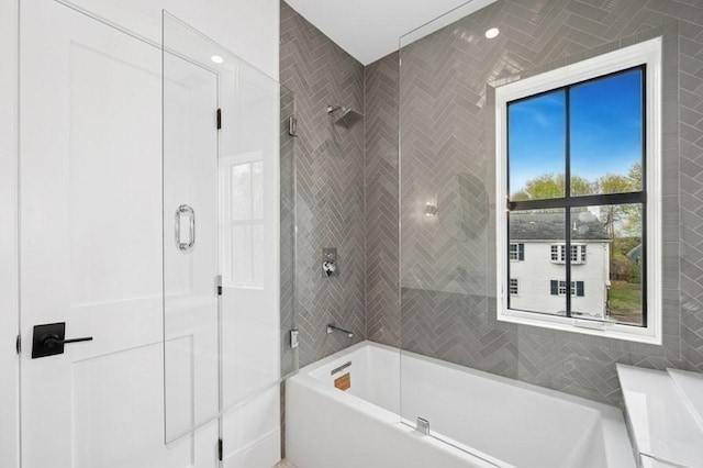 bathroom featuring an enclosed shower and a tub