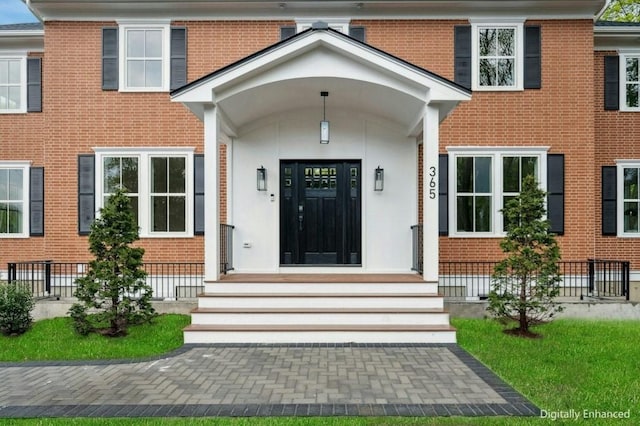 entrance to property with brick siding