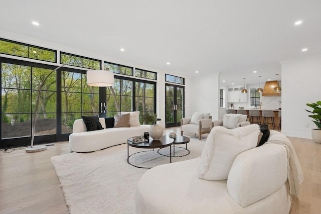 living room with recessed lighting and light wood-style flooring