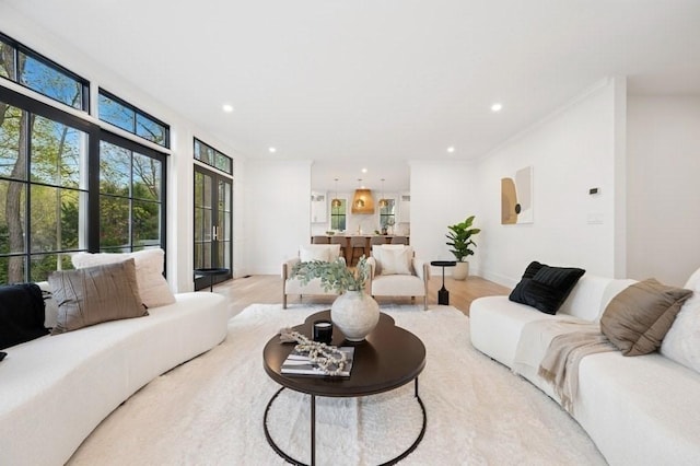 living area with recessed lighting, baseboards, and light wood-style floors