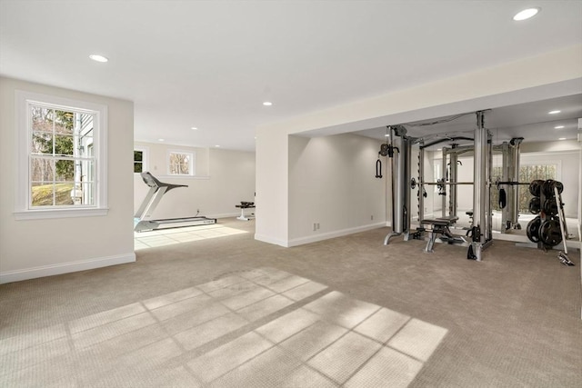 exercise room with recessed lighting, baseboards, and light carpet