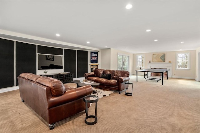 living room with recessed lighting, light colored carpet, a fireplace, and baseboards