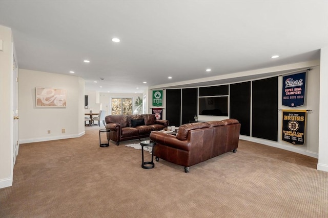 living area featuring recessed lighting, baseboards, and light carpet