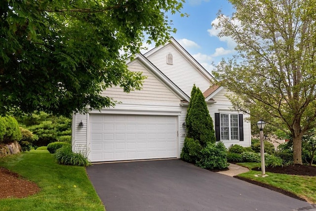 49 Champlain Cir, Plymouth, MA 02360 - view of front facade with asphalt driveway, a garage, and a front yard