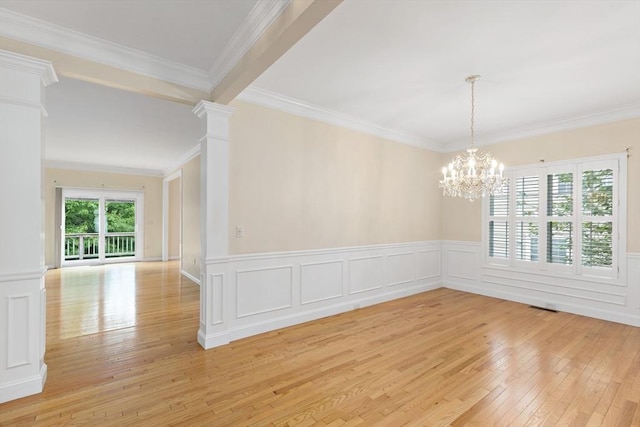 49 Champlain Cir, Plymouth, MA 02360 - empty room featuring decorative columns, light wood finished floors, a chandelier, wainscoting, and crown molding