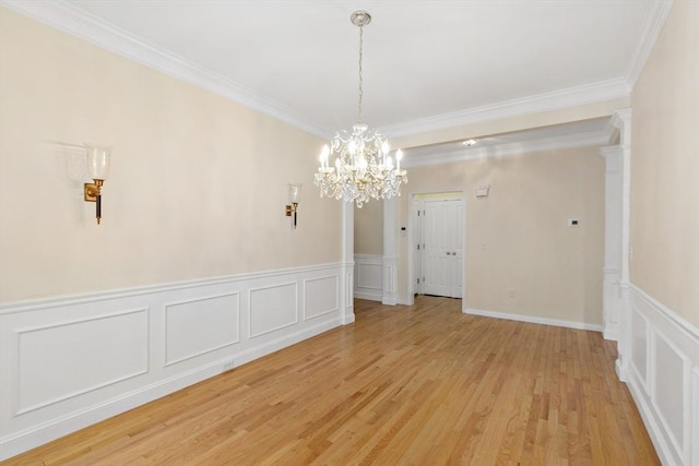 49 Champlain Cir, Plymouth, MA 02360 - unfurnished dining area featuring a decorative wall, light wood-type flooring, a chandelier, crown molding, and a wainscoted wall