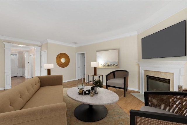 49 Champlain Cir, Plymouth, MA 02360 - living area with ornamental molding, a fireplace with flush hearth, decorative columns, and light wood finished floors