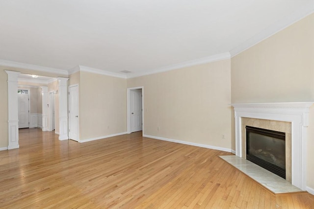 49 Champlain Cir, Plymouth, MA 02360 - unfurnished living room featuring light wood-style flooring, ornamental molding, a tile fireplace, and decorative columns