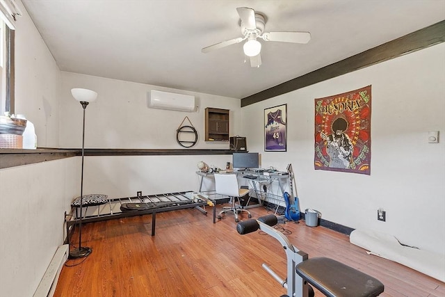 415 Holtshire Rd, Orange, MA 01364 - exercise area with a wall unit AC, a ceiling fan, wood finished floors, and a baseboard heating unit
