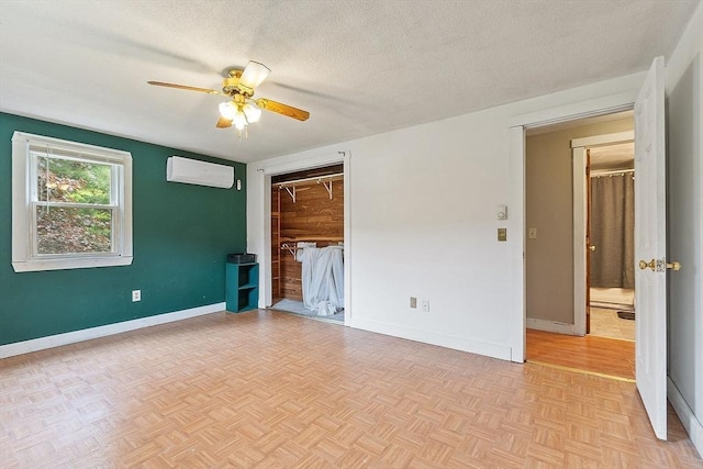 415 Holtshire Rd, Orange, MA 01364 - spare room with a wall mounted air conditioner, ceiling fan, baseboards, and a textured ceiling