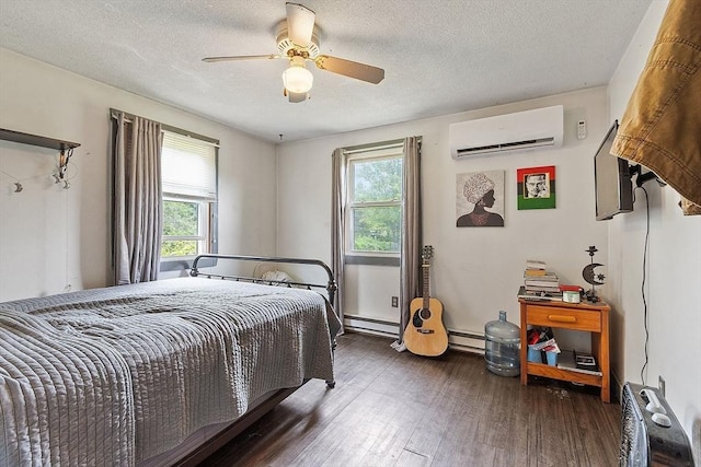 415 Holtshire Rd, Orange, MA 01364 - bedroom with a wall unit AC, multiple windows, wood finished floors, and a textured ceiling