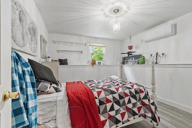 415 Holtshire Rd, Orange, MA 01364 - bedroom with a wall mounted AC, wood finished floors, and baseboards