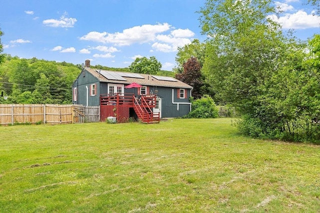 415 Holtshire Rd, Orange, MA 01364 - rear view of property with a wooden deck, stairway, roof mounted solar panels, and a chimney