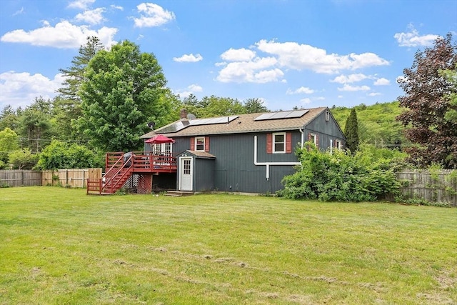 415 Holtshire Rd, Orange, MA 01364 - back of property with stairs, a wooden deck, solar panels, and a chimney