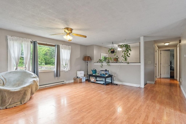 415 Holtshire Rd, Orange, MA 01364 - sitting room featuring baseboard heating, wood finished floors, baseboards, and a textured ceiling