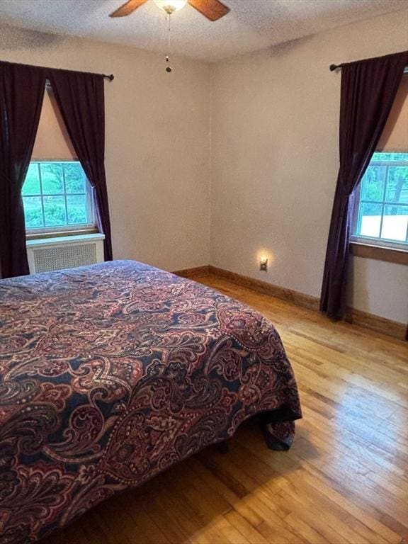 98 Varnum Rd, Dracut, MA 01826 - bedroom with wood finished floors, baseboards, ceiling fan, and a textured ceiling