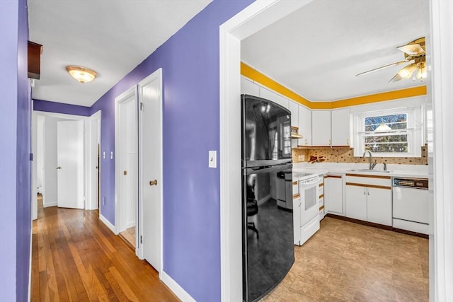 kitchen with white appliances, light countertops, a sink, and white cabinets