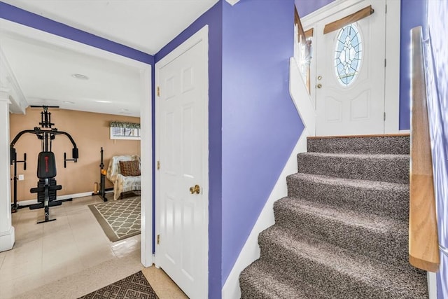 stairway with tile patterned floors and baseboards