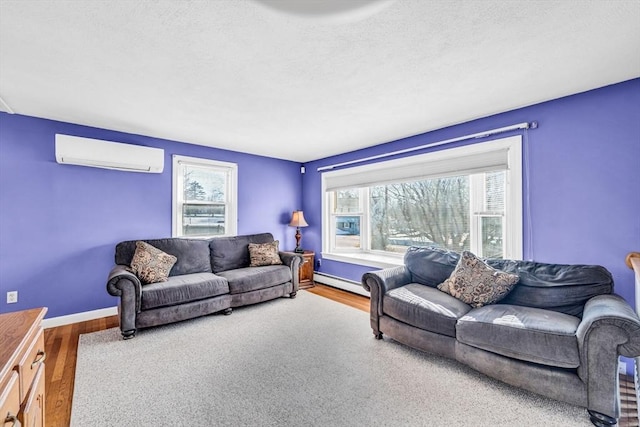 living room with an AC wall unit, a baseboard radiator, wood finished floors, and baseboards