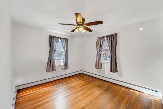 spare room featuring hardwood / wood-style flooring, ceiling fan, and a wealth of natural light