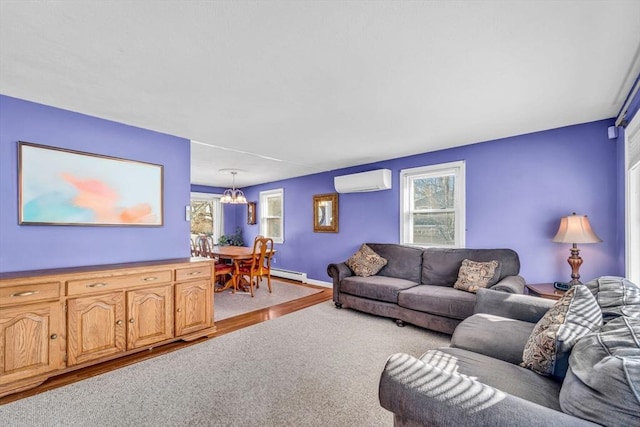 carpeted living area with a chandelier, a baseboard radiator, a wall mounted air conditioner, and baseboards