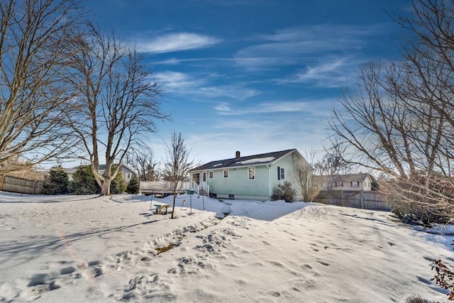 view of snowy exterior featuring fence