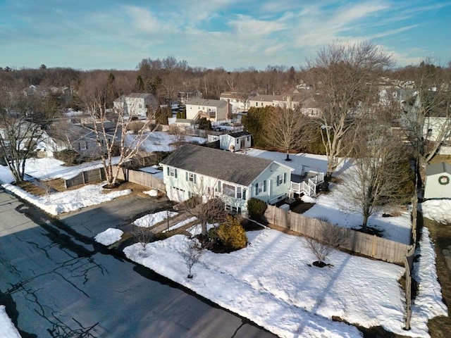 snowy aerial view with a residential view