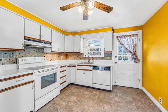 kitchen featuring under cabinet range hood, white appliances, a sink, and light countertops