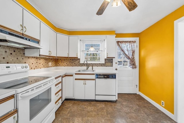 kitchen featuring white appliances, decorative backsplash, a sink, and under cabinet range hood