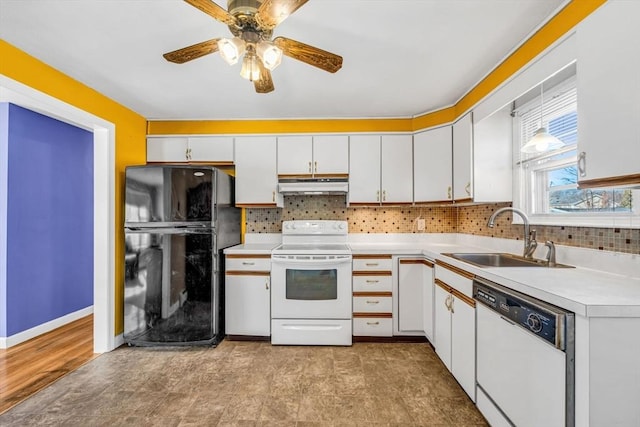 kitchen featuring tasteful backsplash, light countertops, a sink, white appliances, and under cabinet range hood