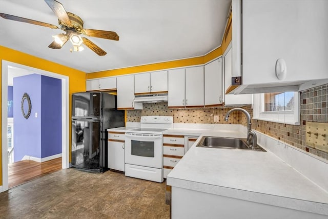 kitchen featuring white electric stove, freestanding refrigerator, light countertops, under cabinet range hood, and a sink