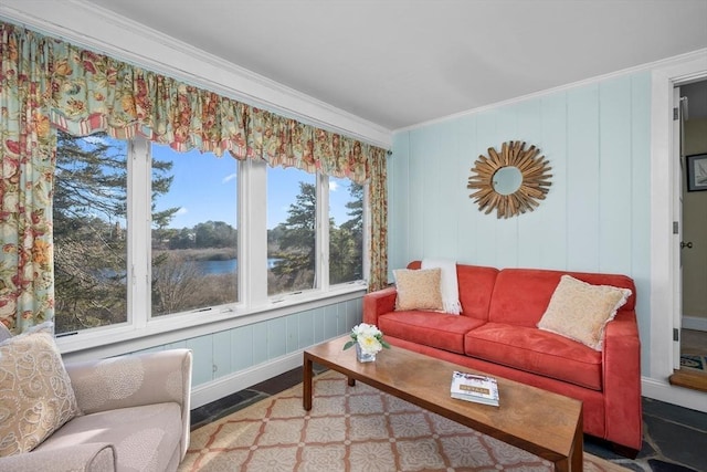 living area with baseboards and crown molding