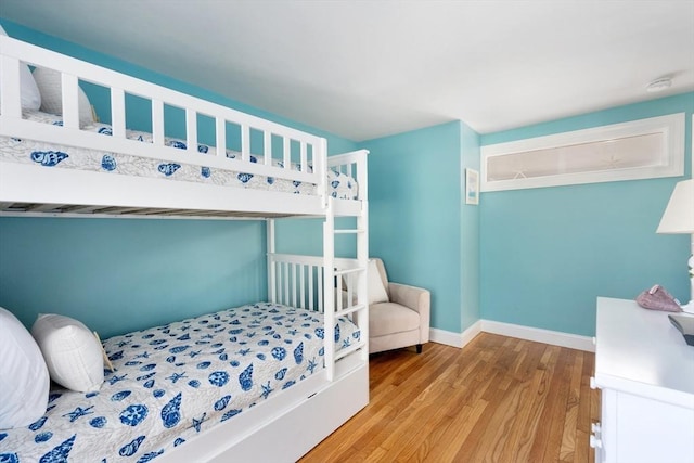 bedroom featuring wood finished floors and baseboards