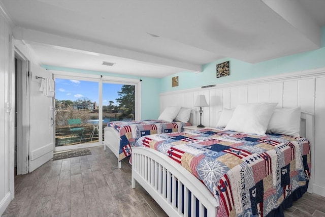 bedroom featuring access to exterior, beam ceiling, visible vents, and wood finished floors