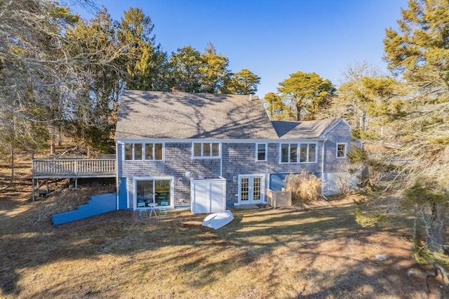 rear view of house featuring a yard, french doors, and a wooden deck