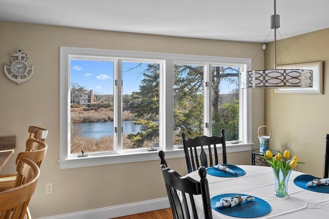 dining area featuring baseboards and wood finished floors