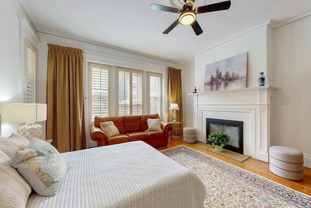 15 Garrison Rd, Brookline, MA 02445 - bedroom with wood finished floors, ornamental molding, a fireplace, and a ceiling fan