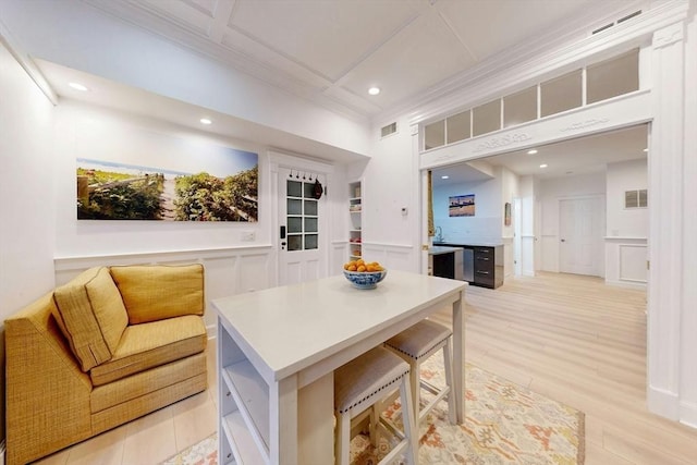 15 Garrison Rd, Brookline, MA 02445 - kitchen with recessed lighting, a decorative wall, a kitchen island, light wood-type flooring, and light countertops