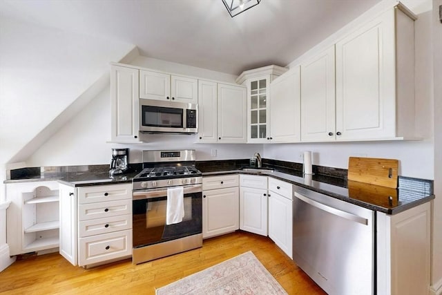 15 Garrison Rd, Brookline, MA 02445 - kitchen featuring stainless steel appliances, white cabinetry, light wood-style floors, and glass insert cabinets
