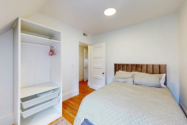 15 Garrison Rd, Brookline, MA 02445 - bedroom with wood finished floors, baseboards, and vaulted ceiling