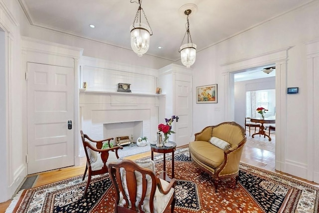 15 Garrison Rd, Brookline, MA 02445 - sitting room with light wood-type flooring and crown molding