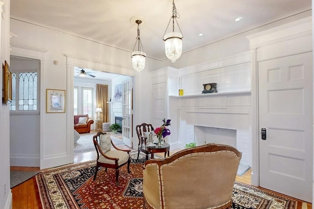 15 Garrison Rd, Brookline, MA 02445 - sitting room featuring wood finished floors, a ceiling fan, crown molding, and baseboards