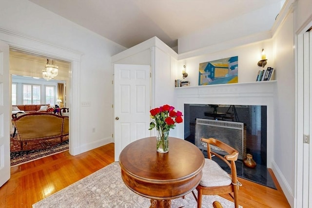 15 Garrison Rd, Brookline, MA 02445 - living room featuring wood finished floors, a fireplace, baseboards, and a chandelier