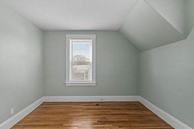 bonus room with lofted ceiling and wood-type flooring