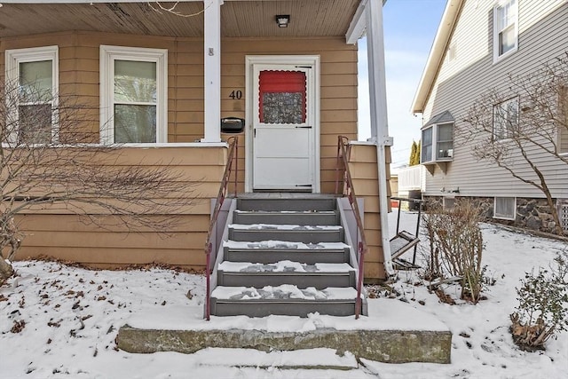 view of snow covered property entrance