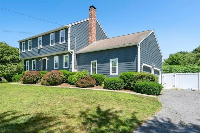 3 Bellingham Rd, Blackstone, MA 01504 - view of side of property featuring a chimney, a gate, asphalt driveway, and a garage