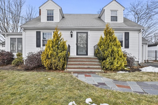 new england style home with a front lawn