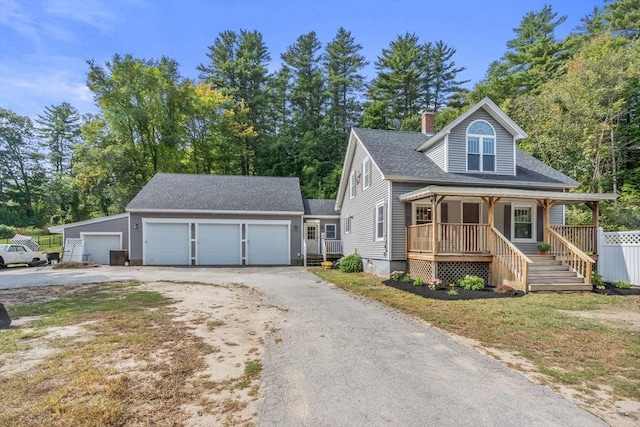 view of front of property with covered porch, an outdoor structure, and a garage